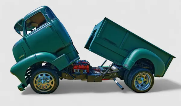 Green vintage truck with tilted cab and bed.