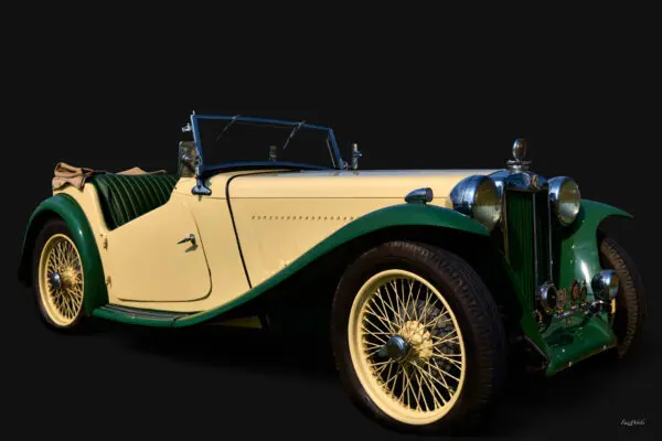 Classic vintage convertible car on black background.