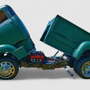 Green vintage truck with tilted cab and bed.