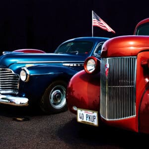Classic vintage cars with American flag background.