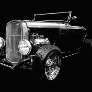 Classic black hot rod on dark background.