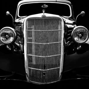 Vintage car front view in black and white.