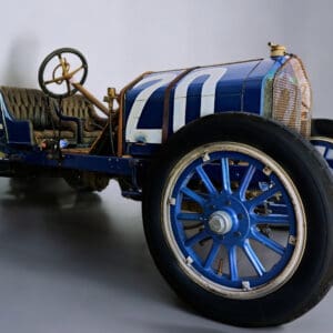 Vintage blue race car with large wheels.
