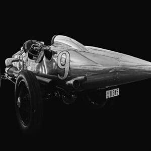 Vintage race car with number nine displayed.