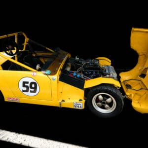 Yellow race car with open hood.
