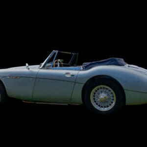 Classic convertible car on black background.