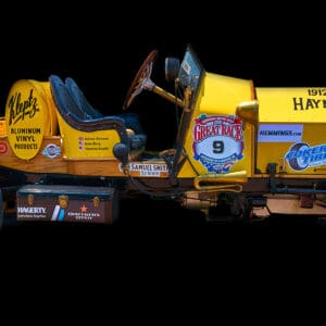 Vintage yellow race car on black background.