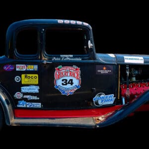 Vintage black race car with decals.