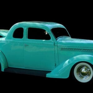 Teal retro coupe on black background