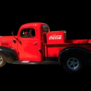 Vintage red pickup truck with Coca-Cola crate